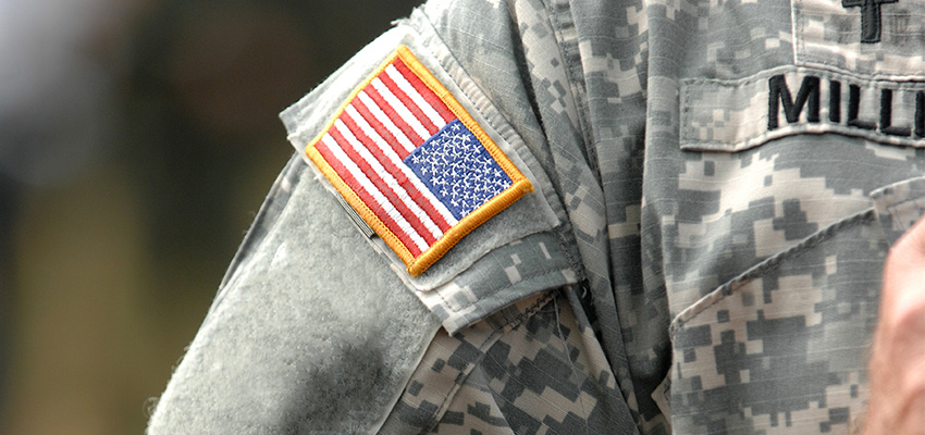 Closeup of a military fatigues with a focus on the American flag patch