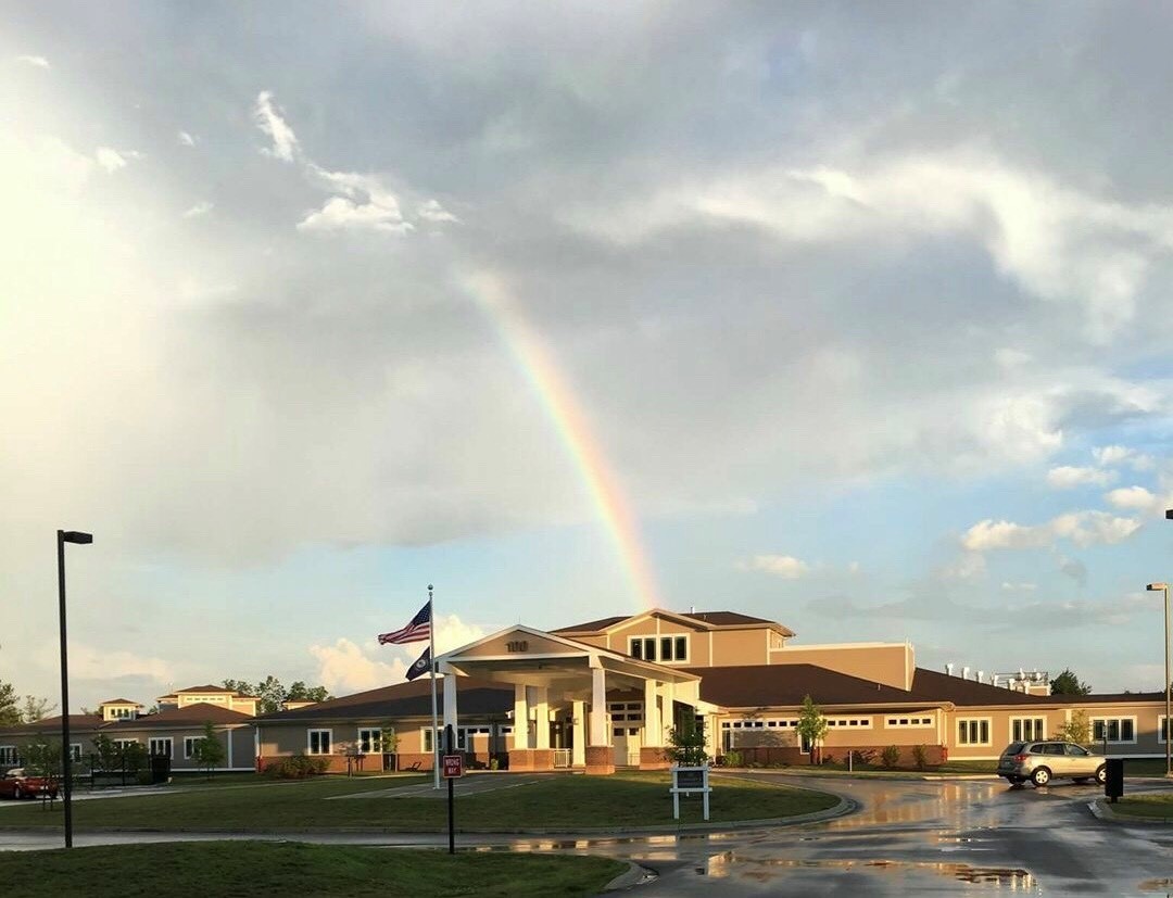 Picture of Radcliff Veterans Center with Rainbow in the sky above.  